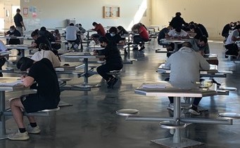 CTF Jumpstart event has people sitting at tables taking a test.