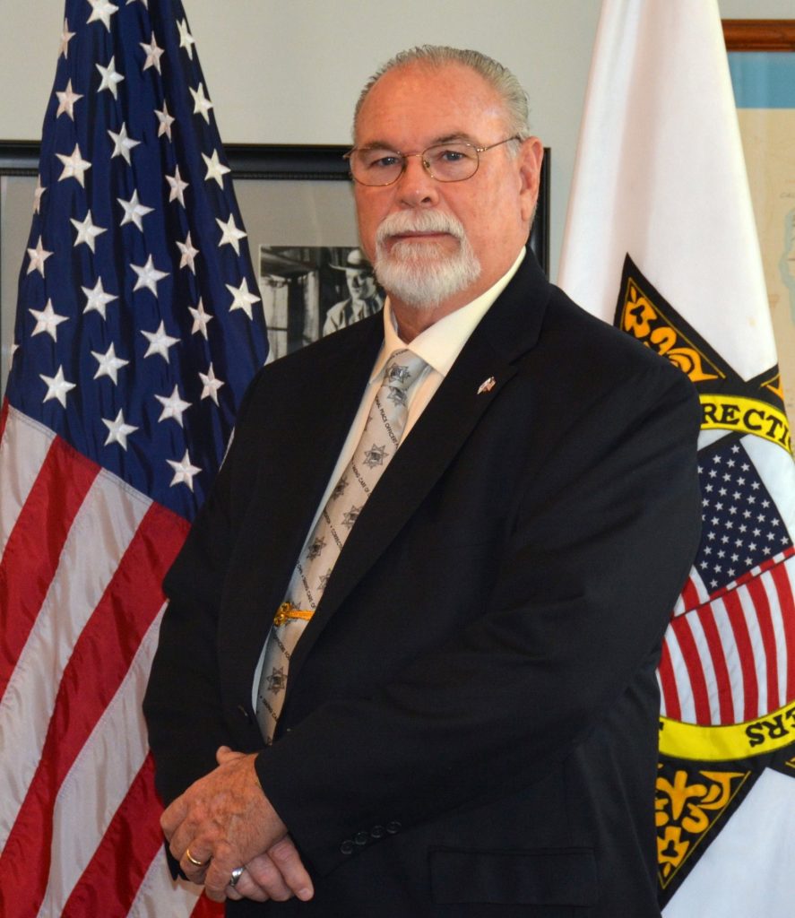 Jim Brown in front of flags