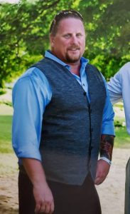 Obituary photo for Jack Mabe showing him in dress vest and shirt.