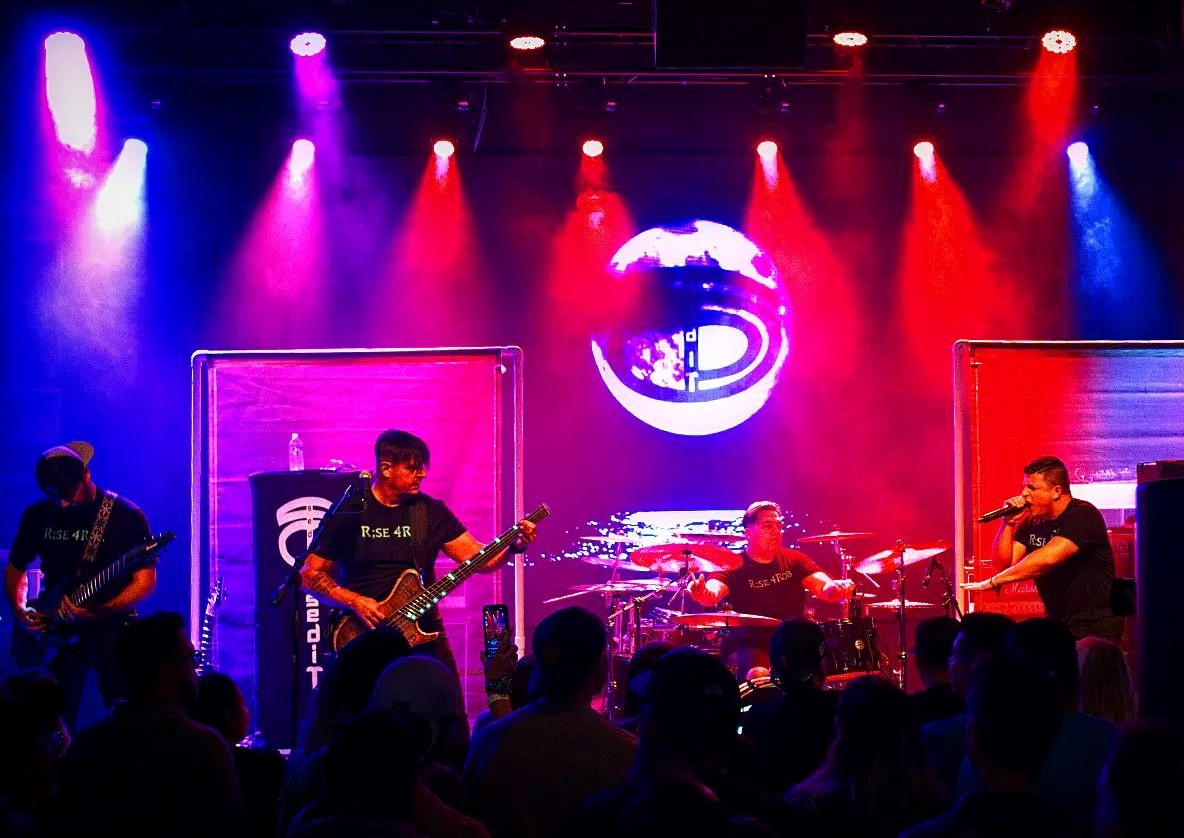 Metal band performing on a stage.