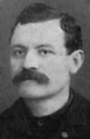 Grainy photo of a man with a mustache.