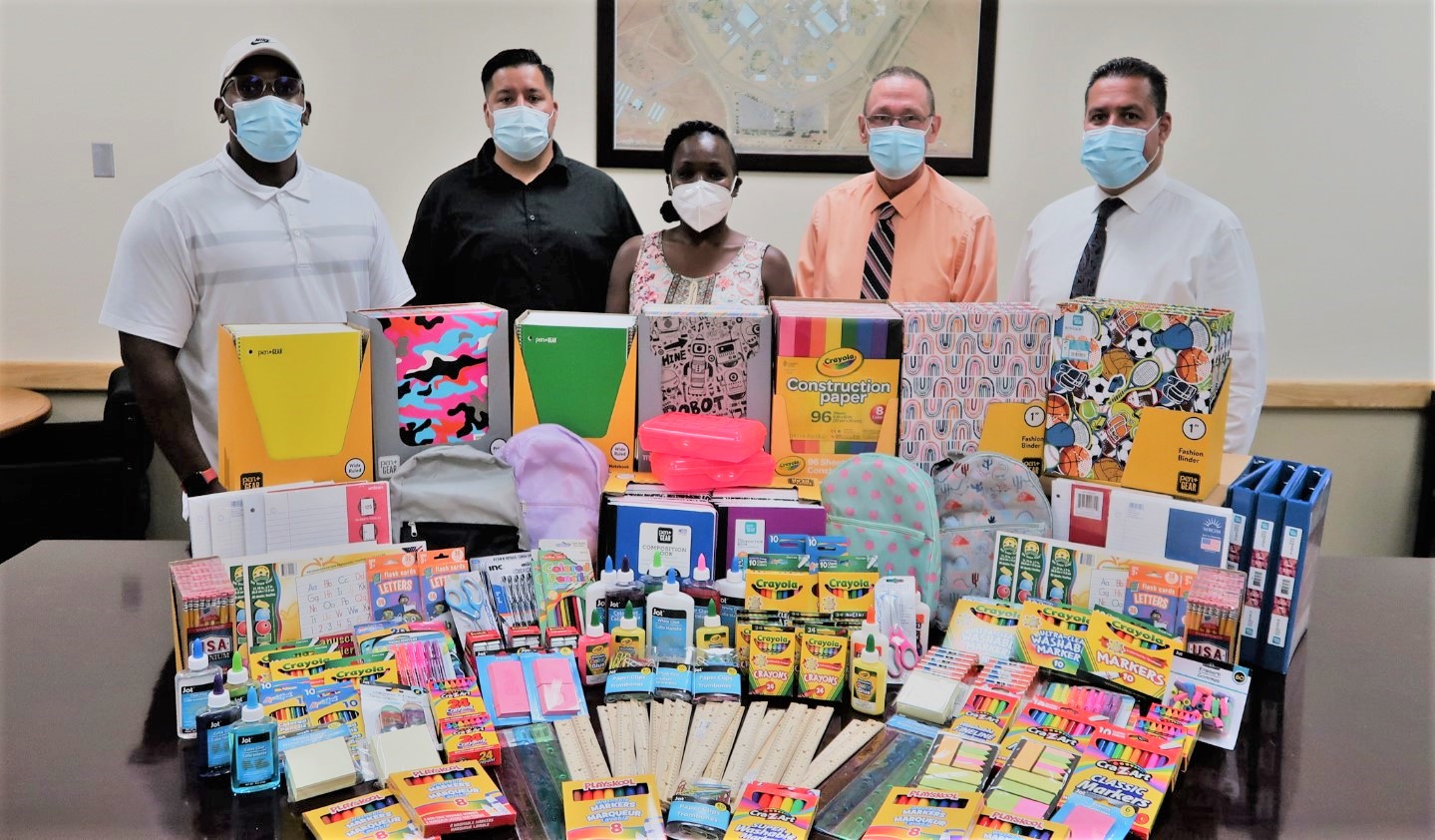Five Avenal prison staff stand with school supply drives. 
