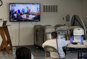 Incarcerated women watch a training video