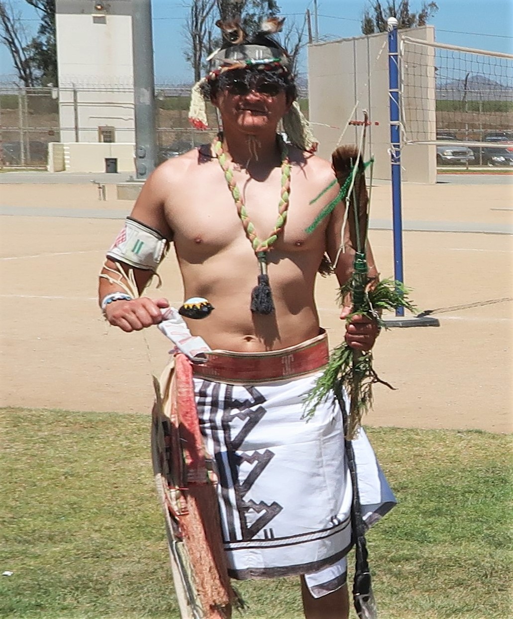 Man wearing traditional Native American clothing.