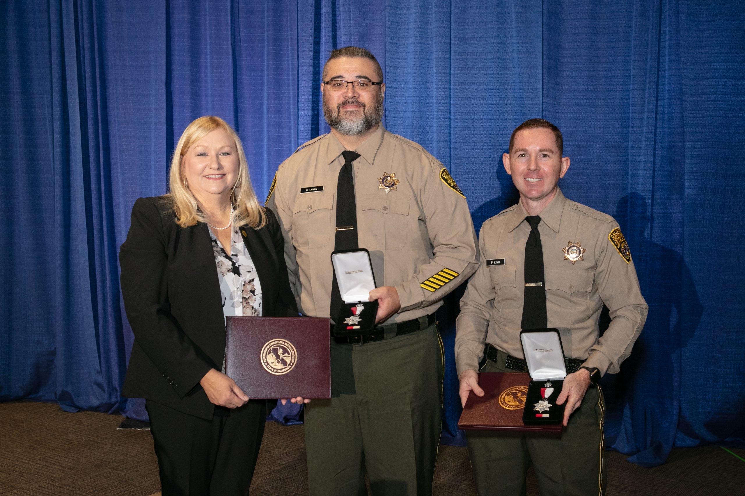 2022 Medal of Valor ceremony with two officers and the secretary.
