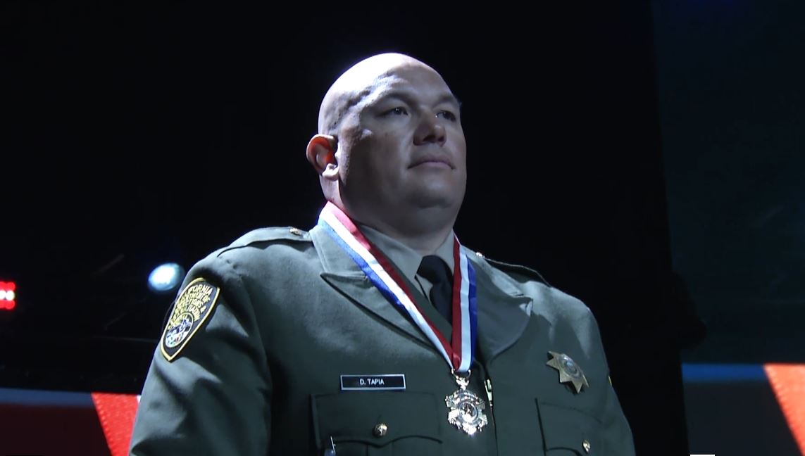 Correctional officer with medal of valor around his neck