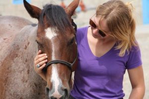 Rebels Farm staff member and a horse at a prison.
