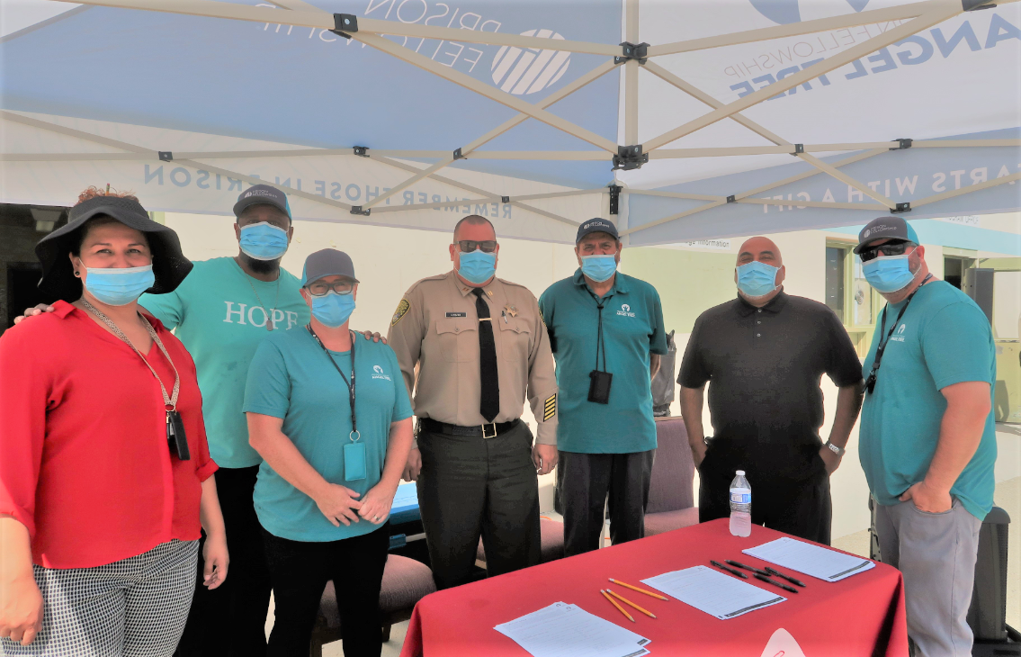 Prison staff and volunteers at an Angel Tree information booth.