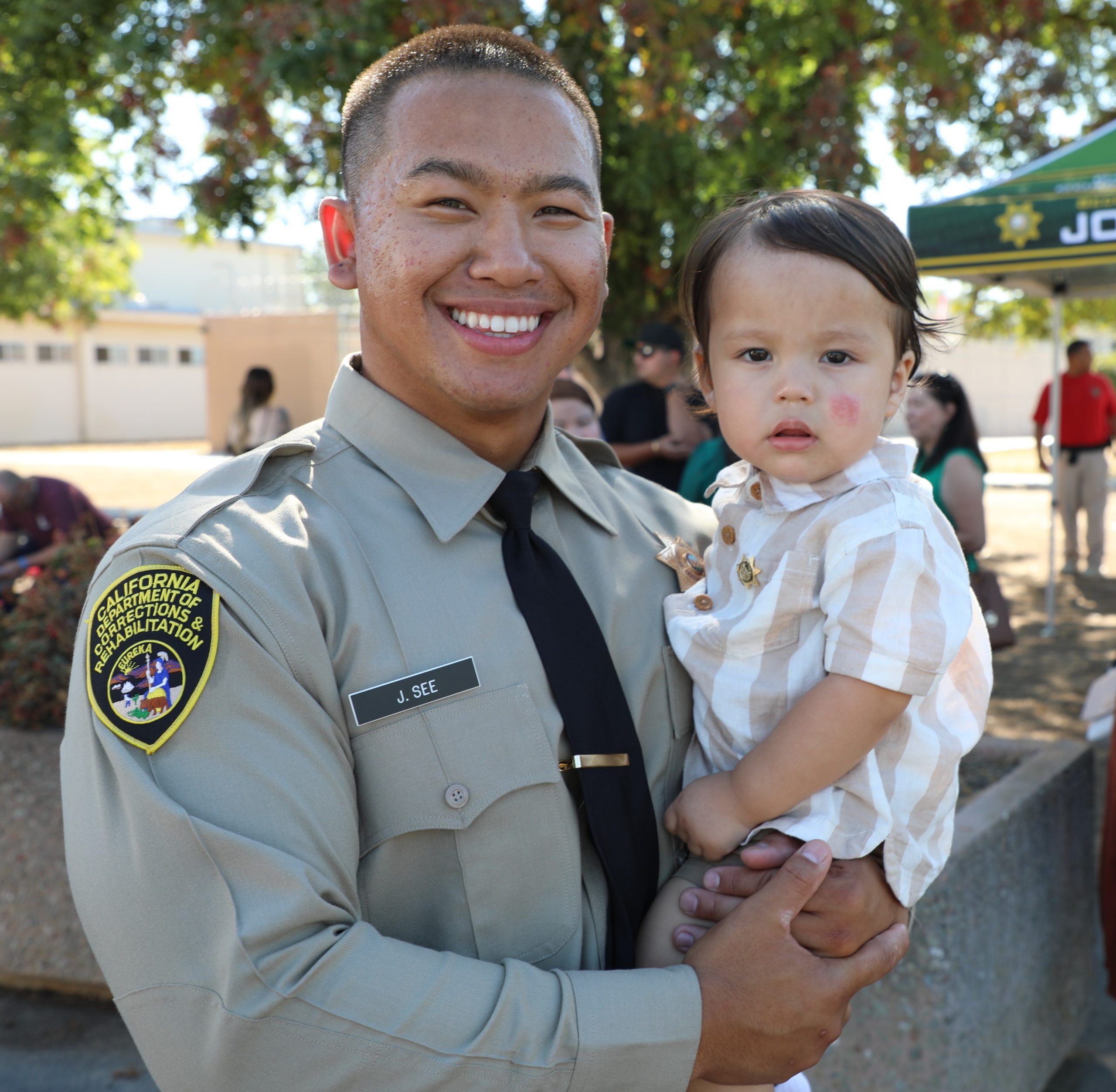 Correctional Officer holds baby.