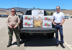 CMC lieutenant, another man and a truck full of food.