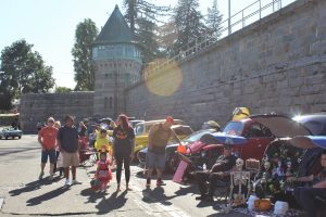 Halloween Trunk-or-Treat event with kids and families walking along classic cars at Folsom Prison.
