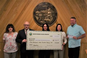 High Desert Prison staff hold a donation check for Lassen High School Baseball Boosters.