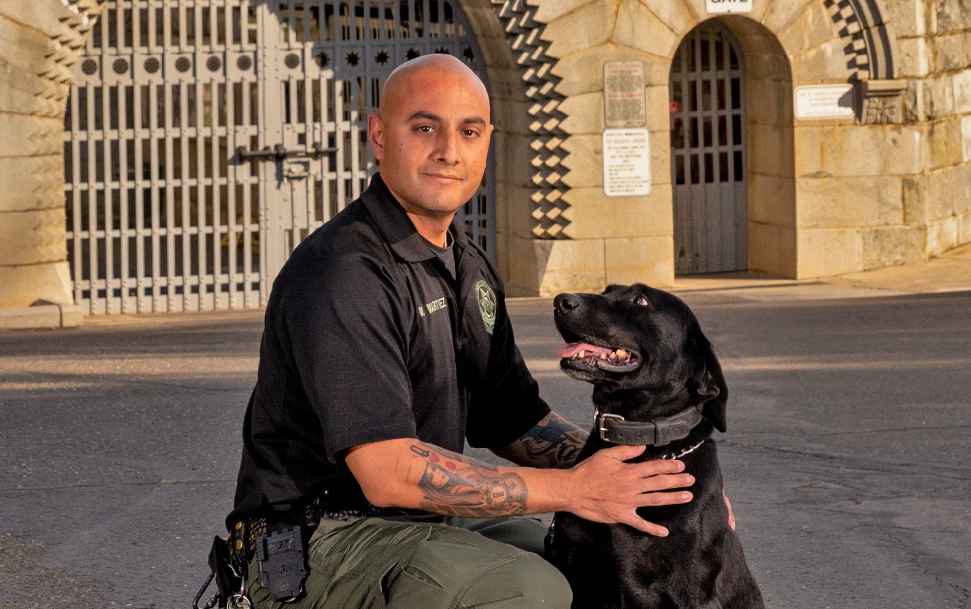 K-9 Blitz and Officer Martinez in front of Folsom State Prison.