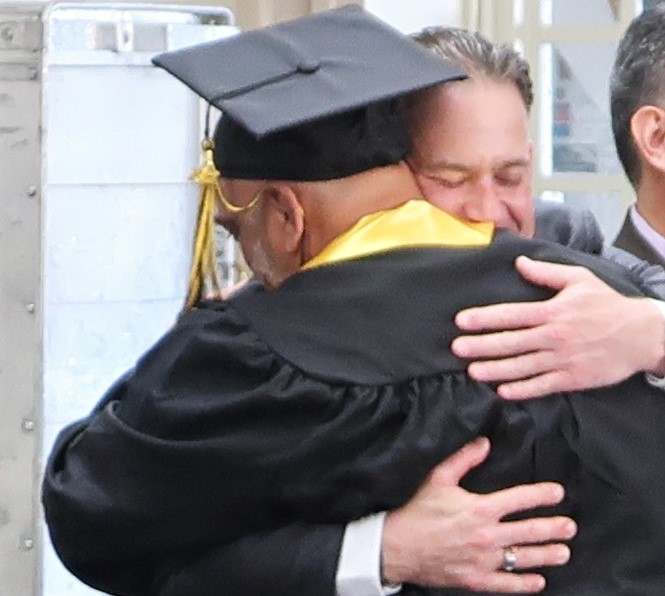 CMC Offender Mentor graduate hugs a program director.