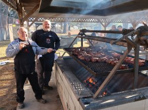 Two CTF staff work a barbecue grill for staff appreciation day.