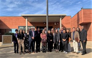 People stand at Administration Building entrance at Mule Creek State Prison.