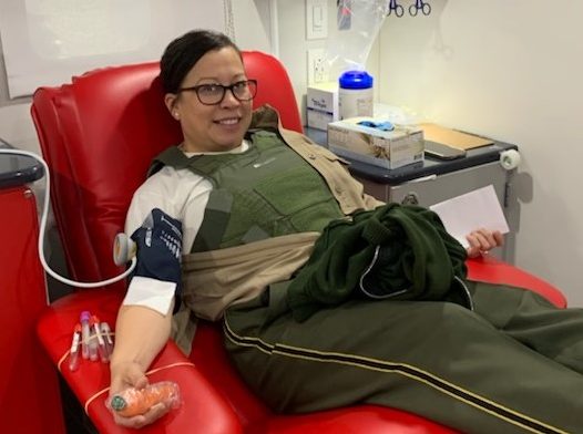 CDCR officer in uniform donates blood.