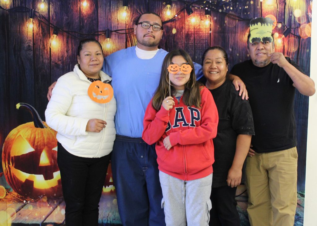 Halloween photo backdrop at PVSP with a family posing in front of it.