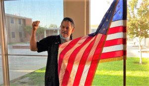 Ignacio Leon with American flag at the correctional training center.