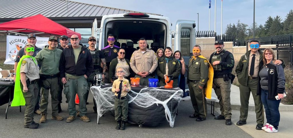 Staff from Pelican Bay at a Halloween trunk-or-treat community event.