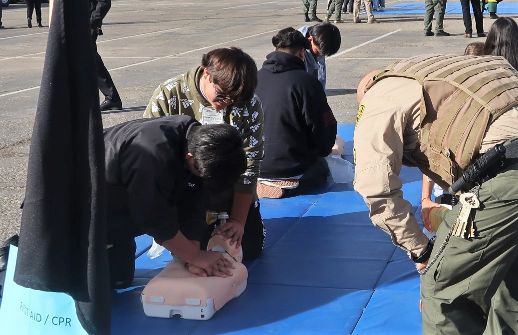 Young people learn CPR by using dummies to practice on.