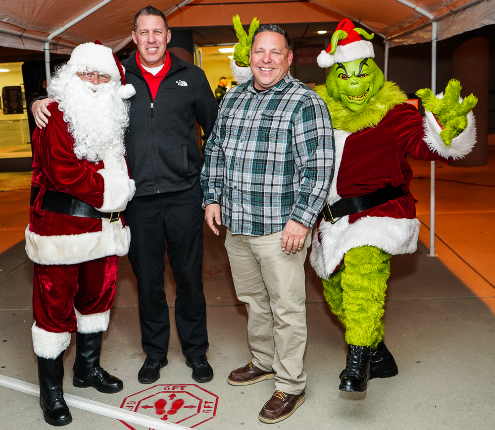 Santa, Grinch and two prison employees.