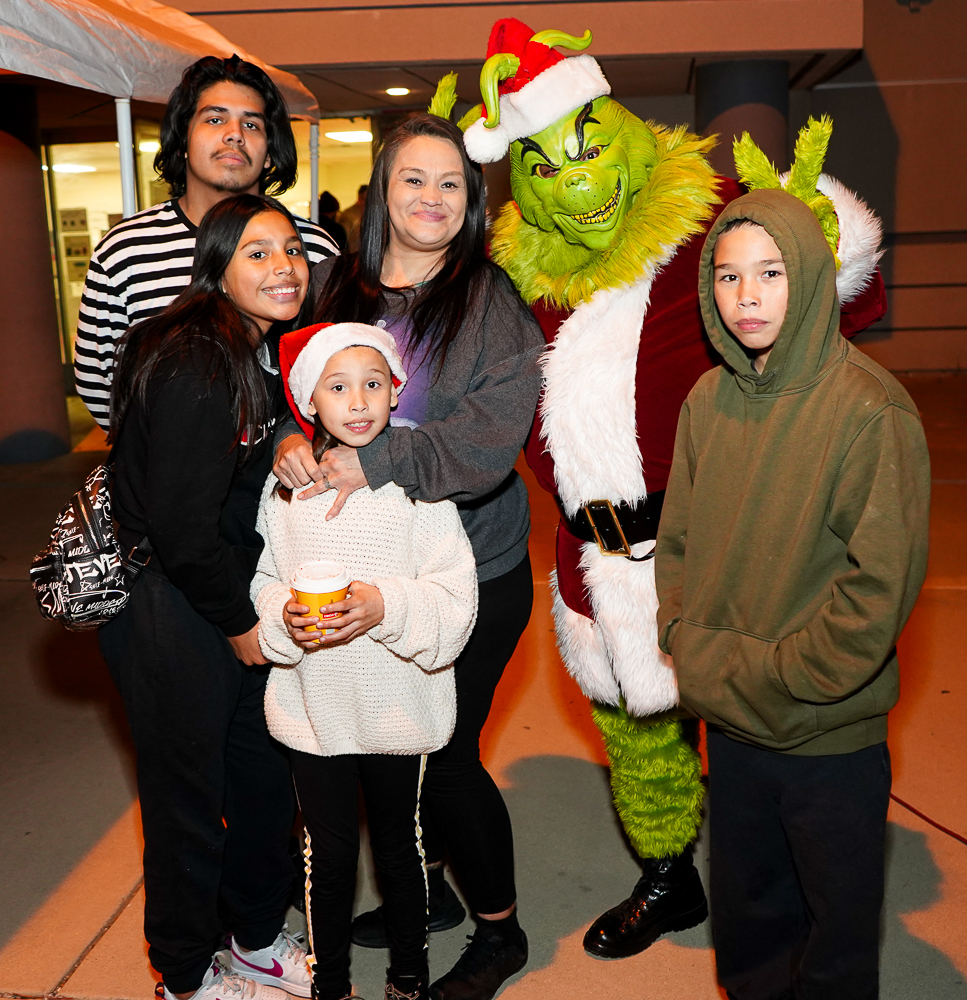 The Grinch with a family of five at the California Institution for Men Grinchmas.