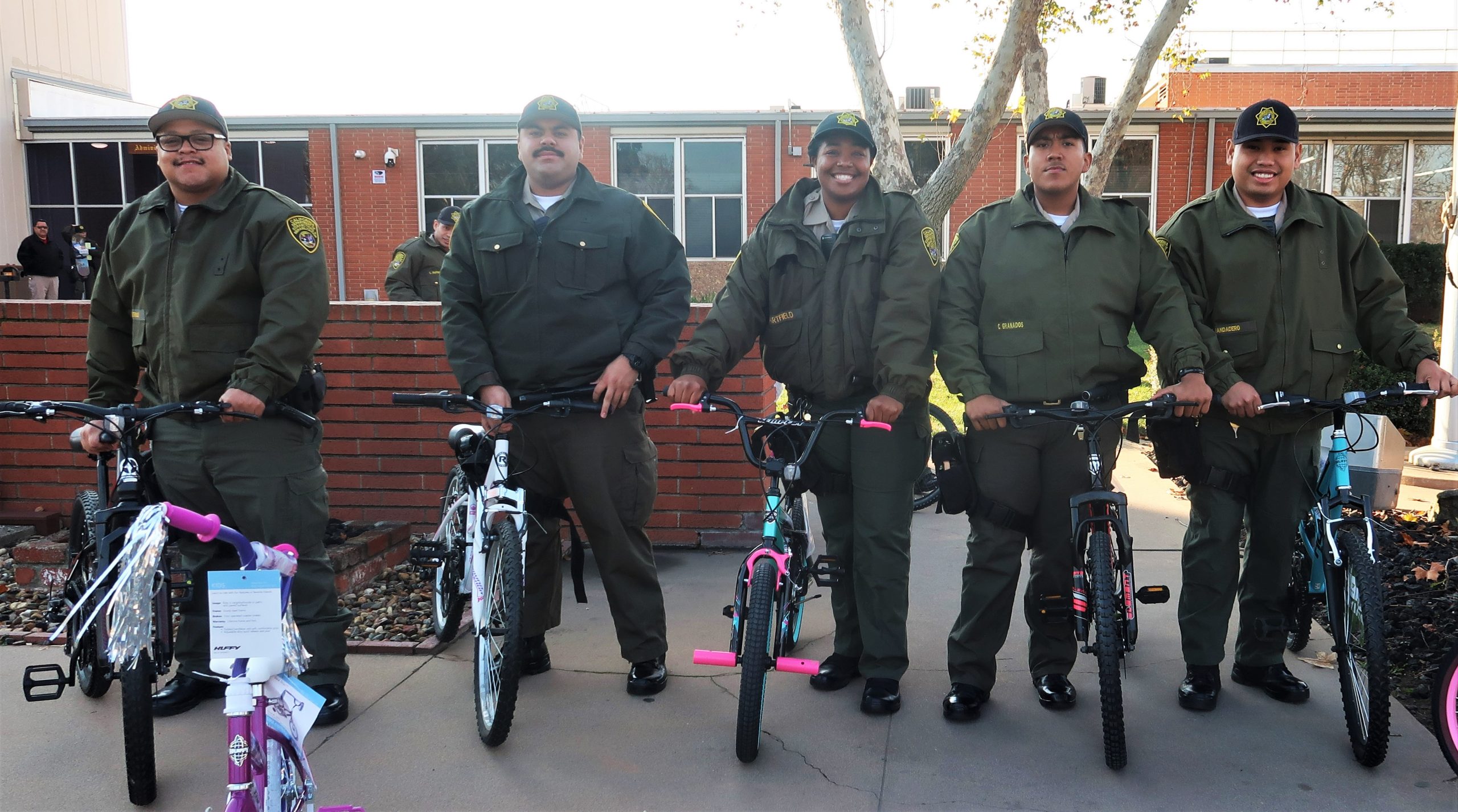 Correctional training center cadets stand beside bicycles.