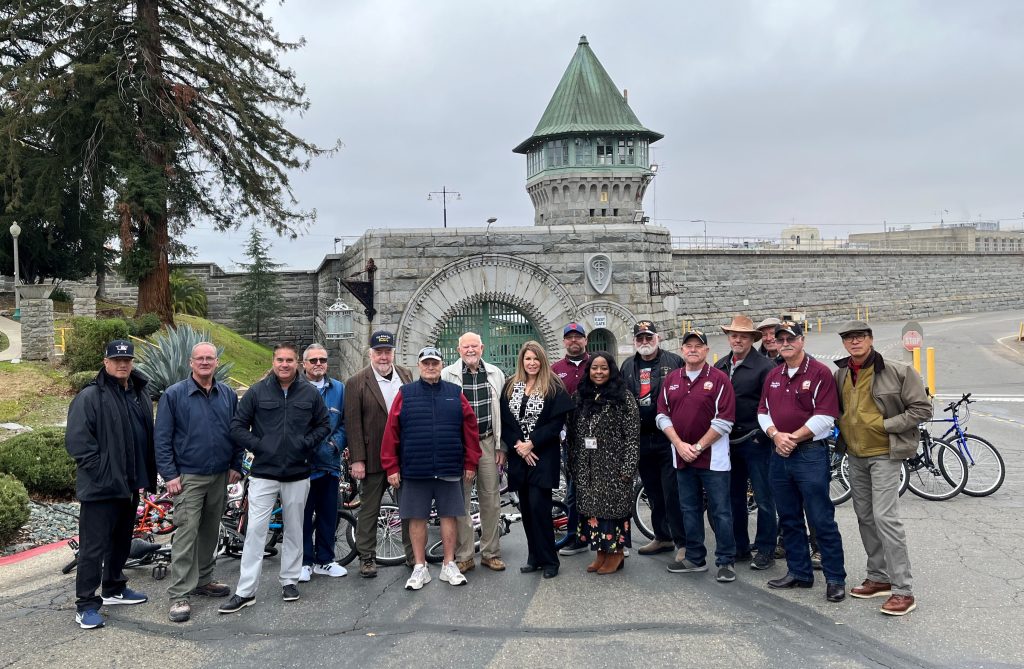 Group of people stand in front of Folsom prison.