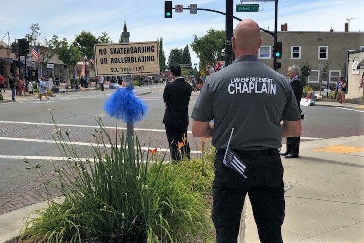 Retired sergeant Chappelle wearing a chaplain shirt during a street event.