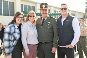 Ken Chappelle wearing sergeant uniform with his family at the training center.