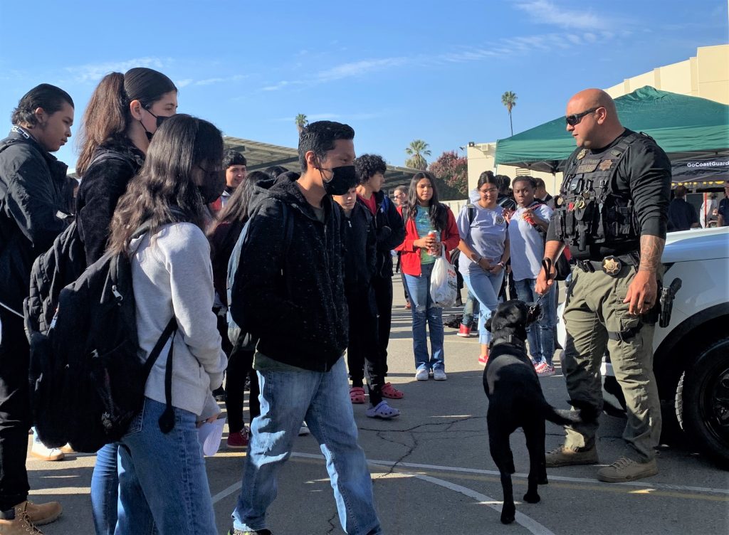 High school students meet PVSP officer and a K-9 after Breakfast with the Blue.