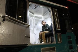 PVSP Family night with kids sitting in a staff area of a prison bus.