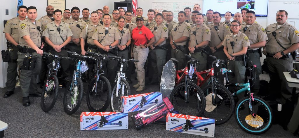 Correctional training center cadets and their sergeant with gifts to be donated.