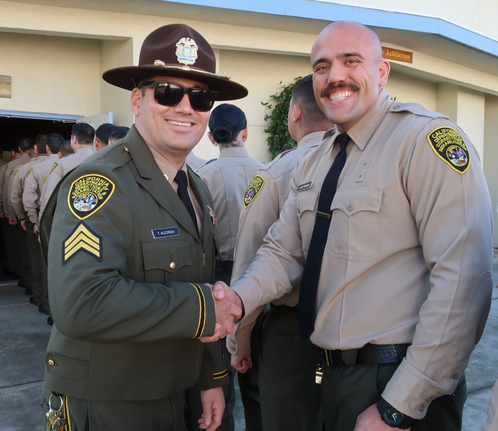 A CDCR sergeant shakes hands with a cadet.
