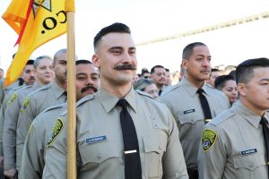 Correctional officer cadets line up for an academy graduation.