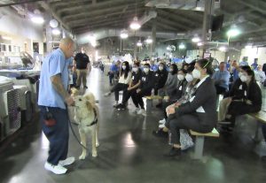 Incarcerated dog trainer speaking to students touring a prison.