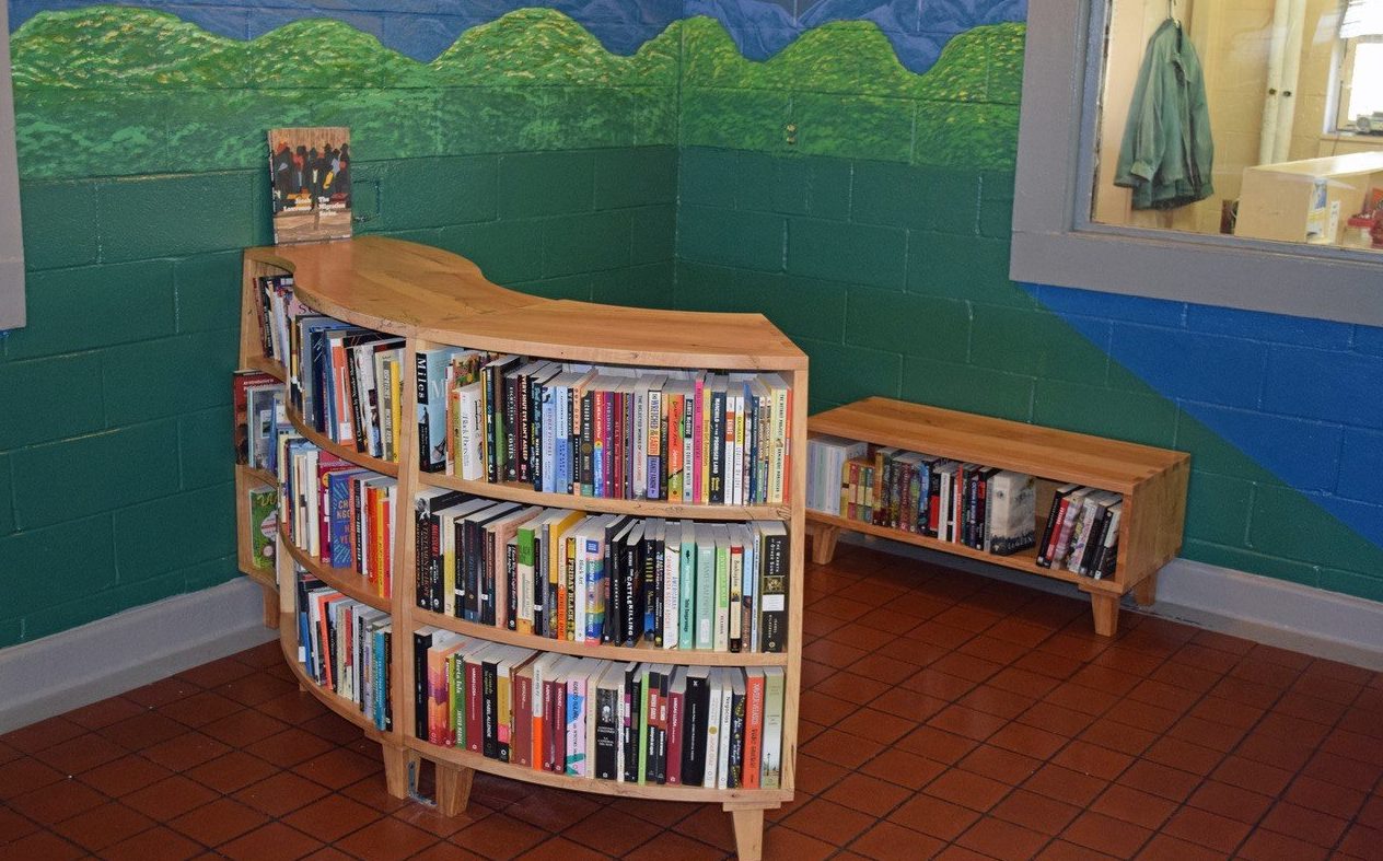 A prison library with curved shelves.