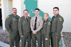 Five family members in correctional officer uniforms.