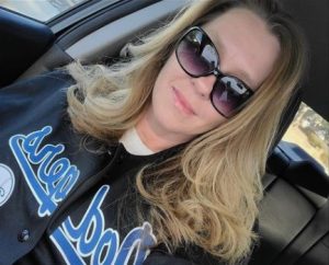 Shelley Cassingham wearing sunglasses and a Dodgers shirt.