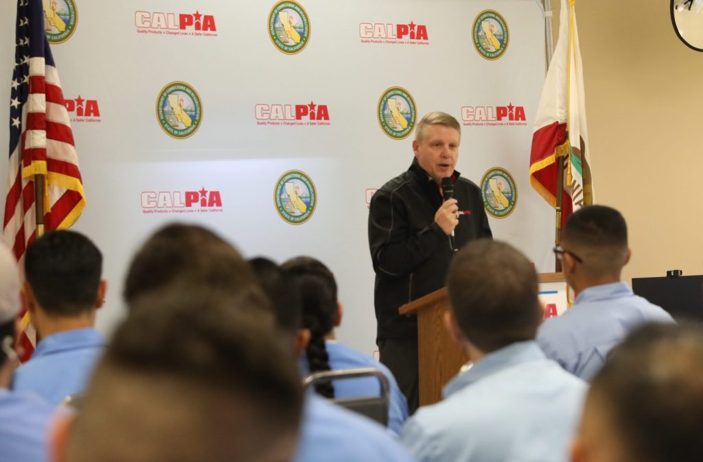 CALPIA general manager speaks at graduation at Avenal State Prison.