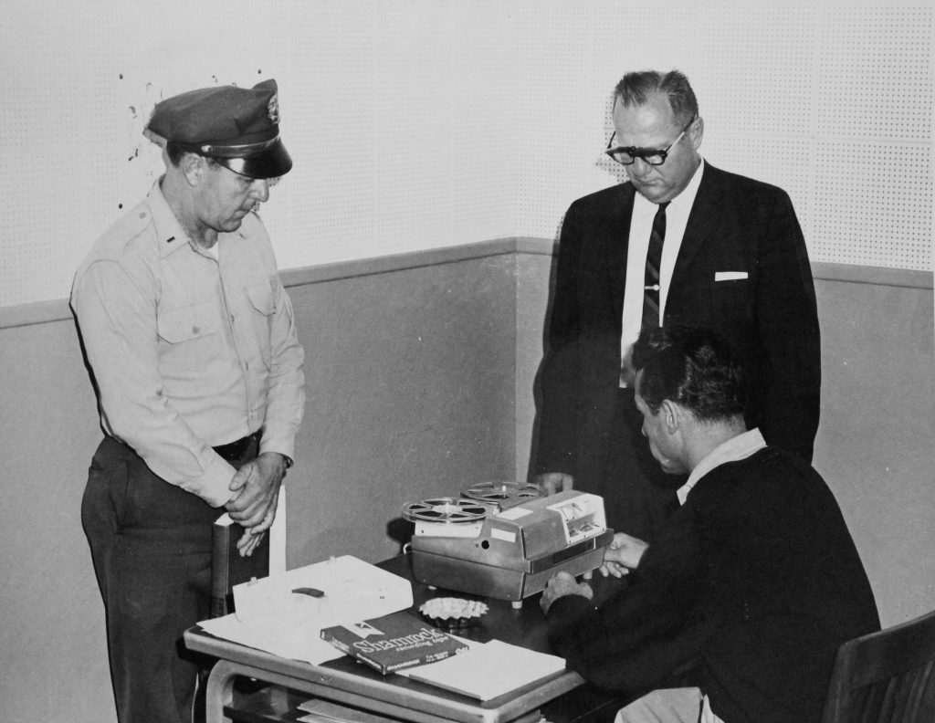 CMC staff working with incarcerated person on the blind project at the prison.