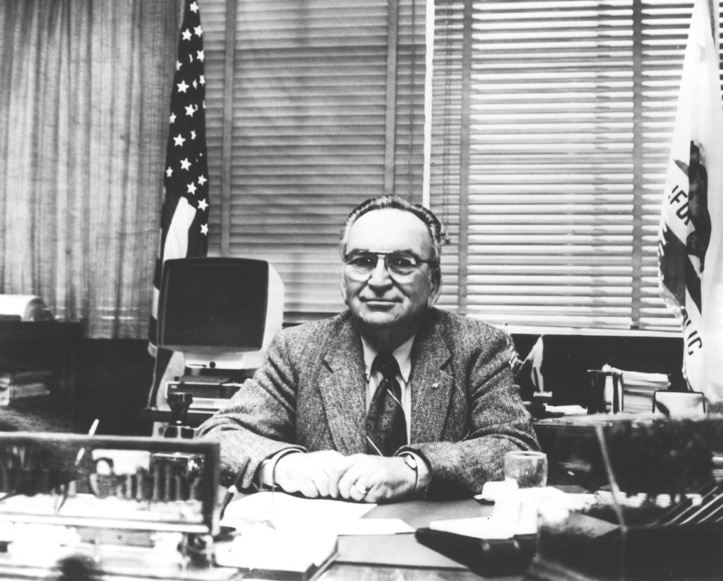 McCarthy sitting at a desk at CMC.