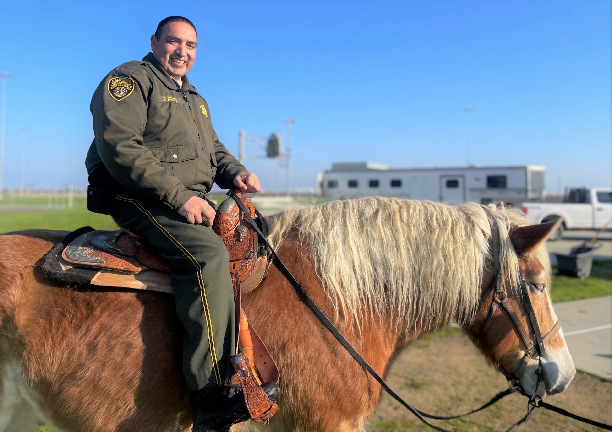 Valley State Prison lieutenant sits atop a horse.