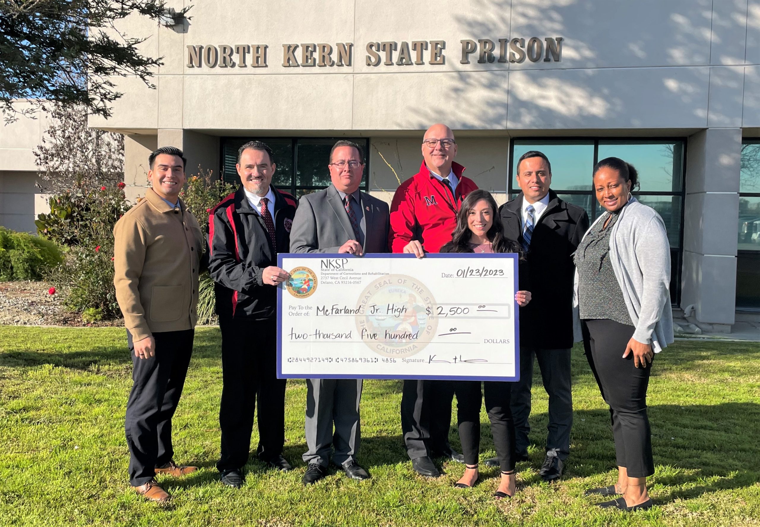 North Kern State Prison (NKSP) staff present check to school officials.