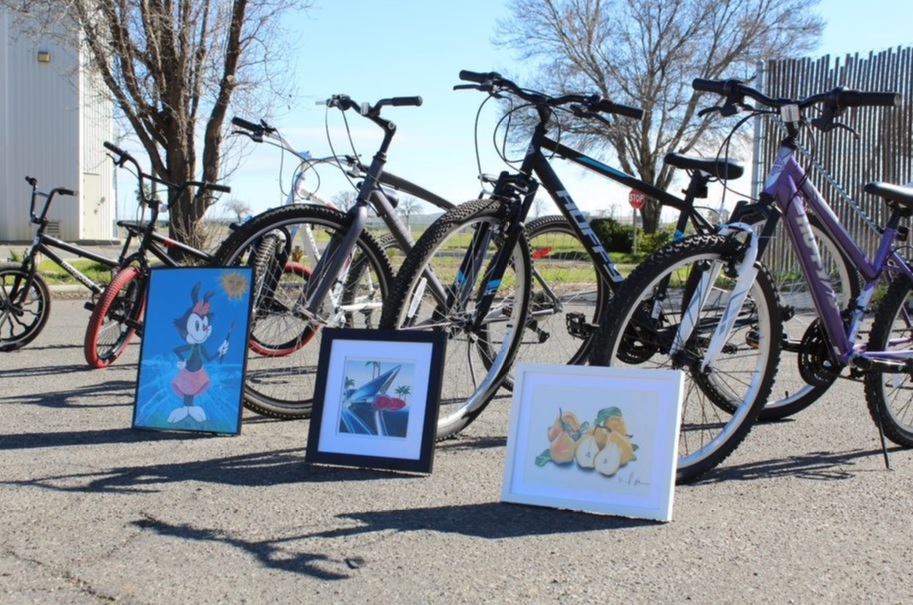 Donated bikes and artwork in a line.