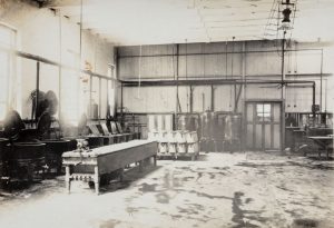 Food service kitchen with cooking pots and large vats in a prison.