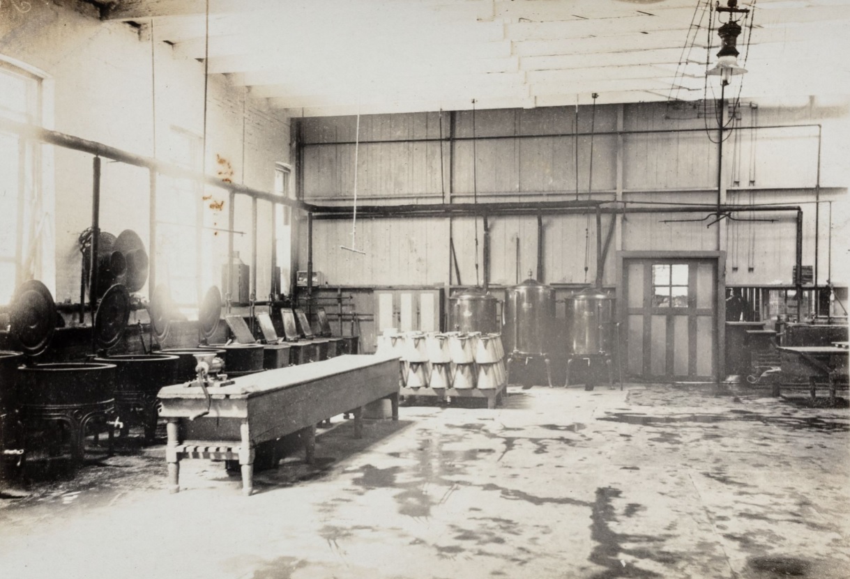 Food service kitchen with cooking pots and large vats in a prison.