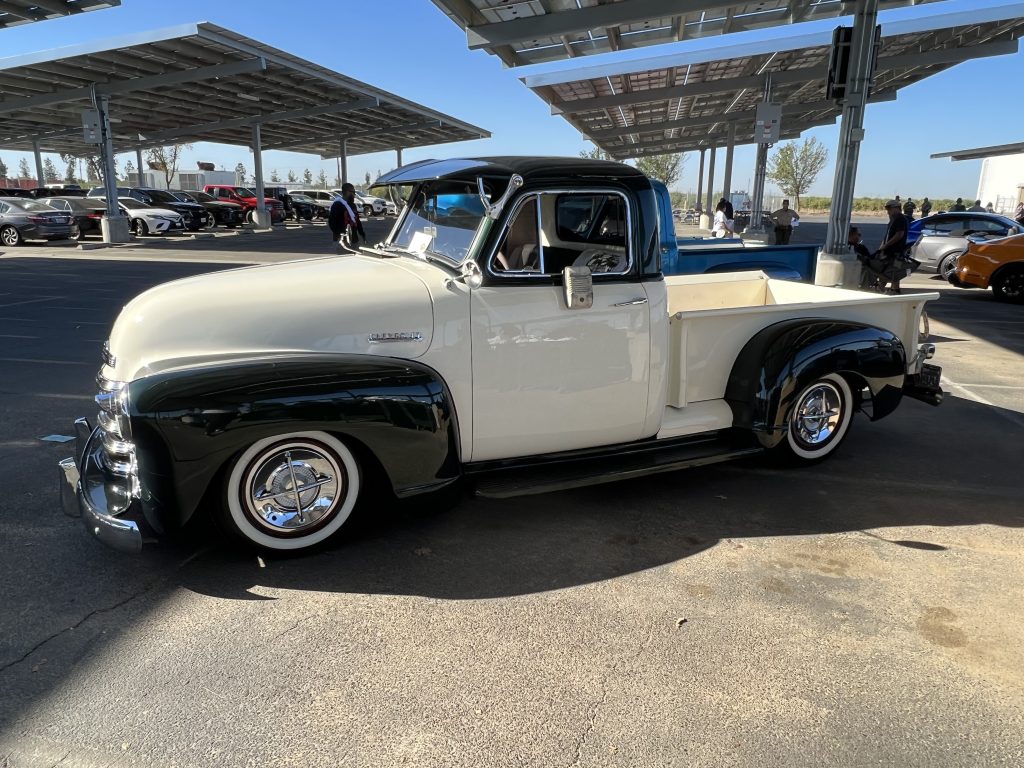 Vintage white chevy pickup truck at a prison car show.