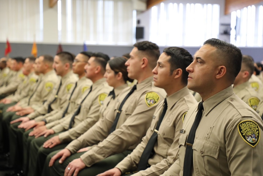 Correctional officer cadets sit as they prepare to graduate.